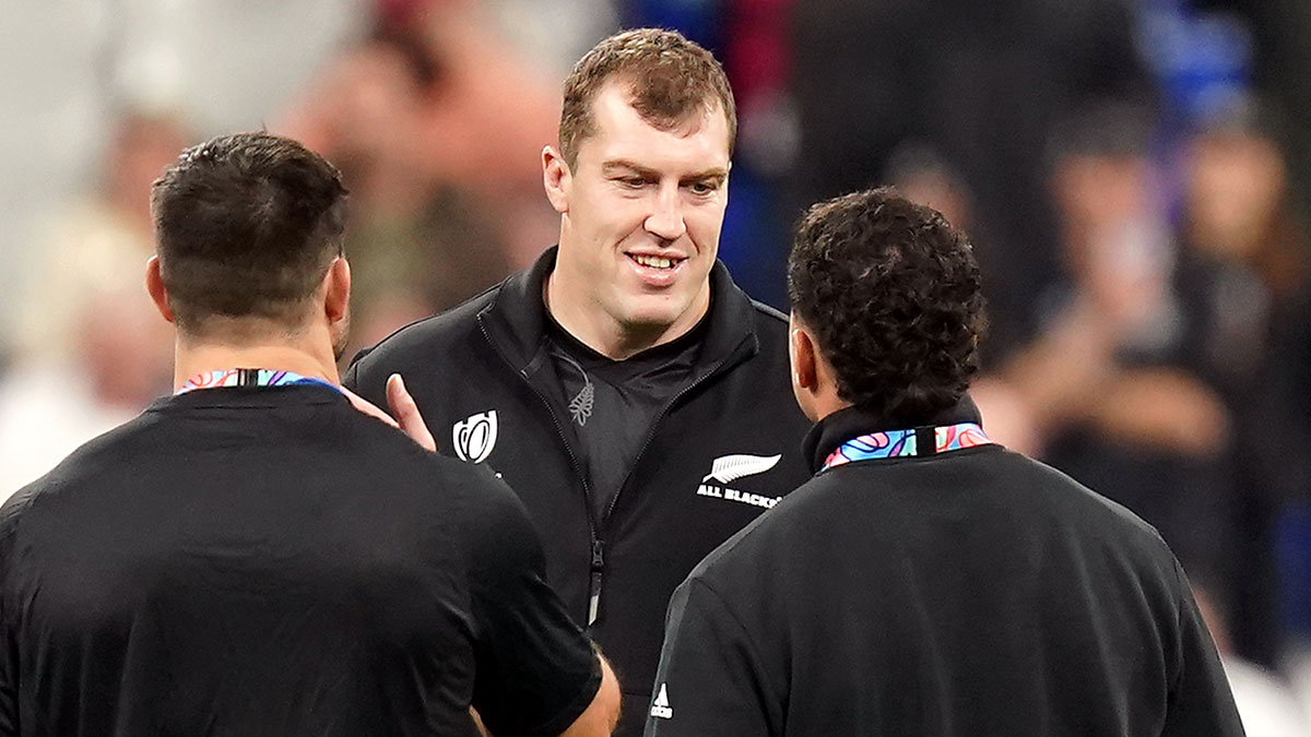 Brodie Retallick talks with team mates at New Zealand v Argentina semi final match during 2023 Rugby World Cup