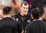 Brodie Retallick talks with team mates at New Zealand v Argentina semi final match during 2023 Rugby World Cup