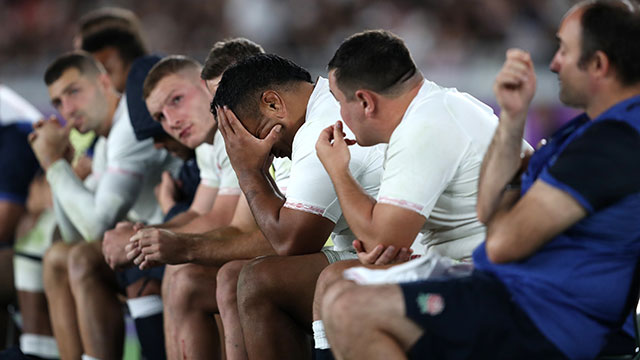 England players on the bench react during the World Cup final match