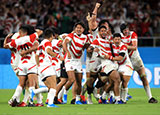 Japan players celebrate a famous victory over Ireland at World Cup