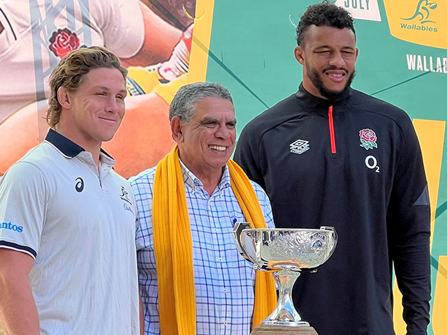 Michael Hooper, Mark Ella and Courtney Lawes stand with the Ella Mobbs Cup