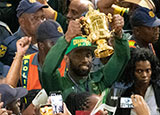 Siya Kolisi carries the Webb Ellis Cup through OR Tambo International Airport