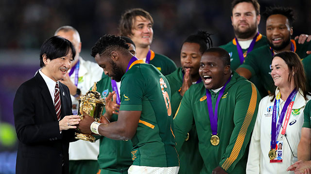 Siya Kolisi is presented with the Webb Ellis Cup by Crown Prince Akishino