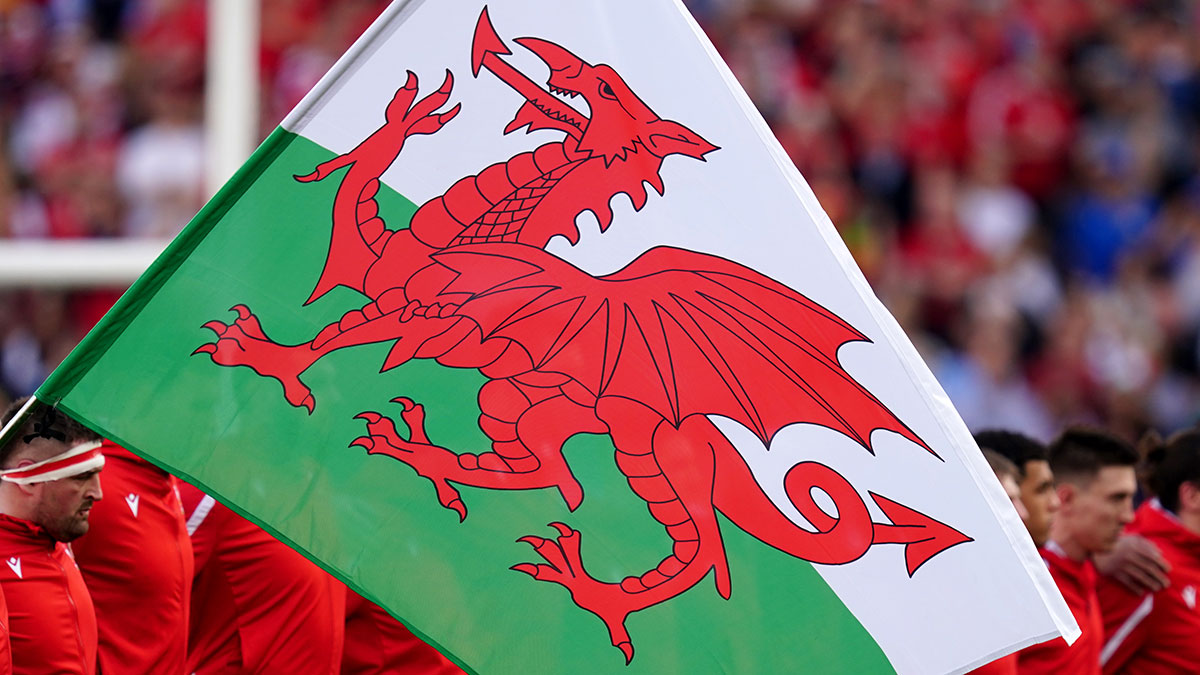 Welsh flag in front of Wales players before Italy v Wales match in 2023 Six Nations